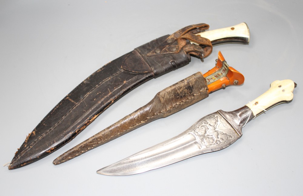 An Indian kukri c.1900, blade 31cms integral with hilt, layered ivory and horn grips, nickel pommel,